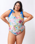 Photo of a woman wearing a colorful seashell inspired shoulder-tie one-piece swim suit