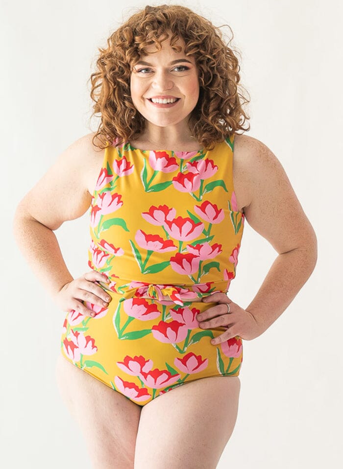 Photo of a woman wearing a Claus swim crop top and a Claus swim bottom