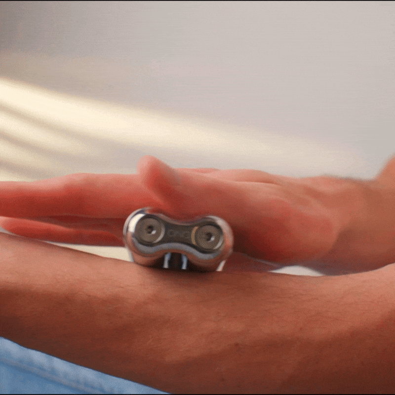 eam_Full | ONO Roller Steel heavy weighted fidget toy in hand with red background